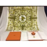 A boxed Hermes link scarf ring and "Les Tuileries" silk scarf