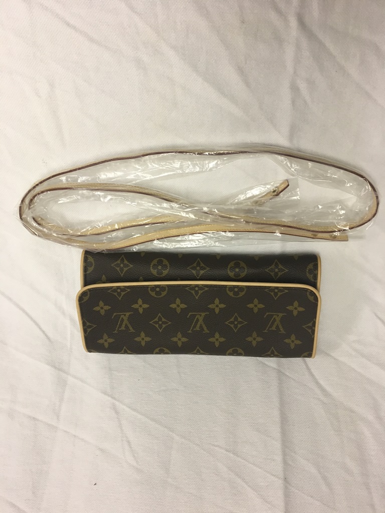A Louis Vuitton monogram pattern clutch bag and strap with suede interior;