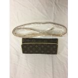 A Louis Vuitton monogram pattern clutch bag and strap with suede interior;