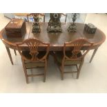 A leather-topped yew dining table;