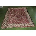 A large red ground wool carpet, 260cm x 210cm