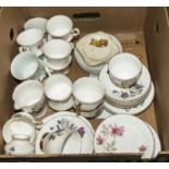 A box containing part tea sets