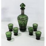 A green glass decanter and six glasses