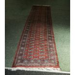 A large red ground wool runner