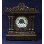 A Victorian walnut mantle clock.