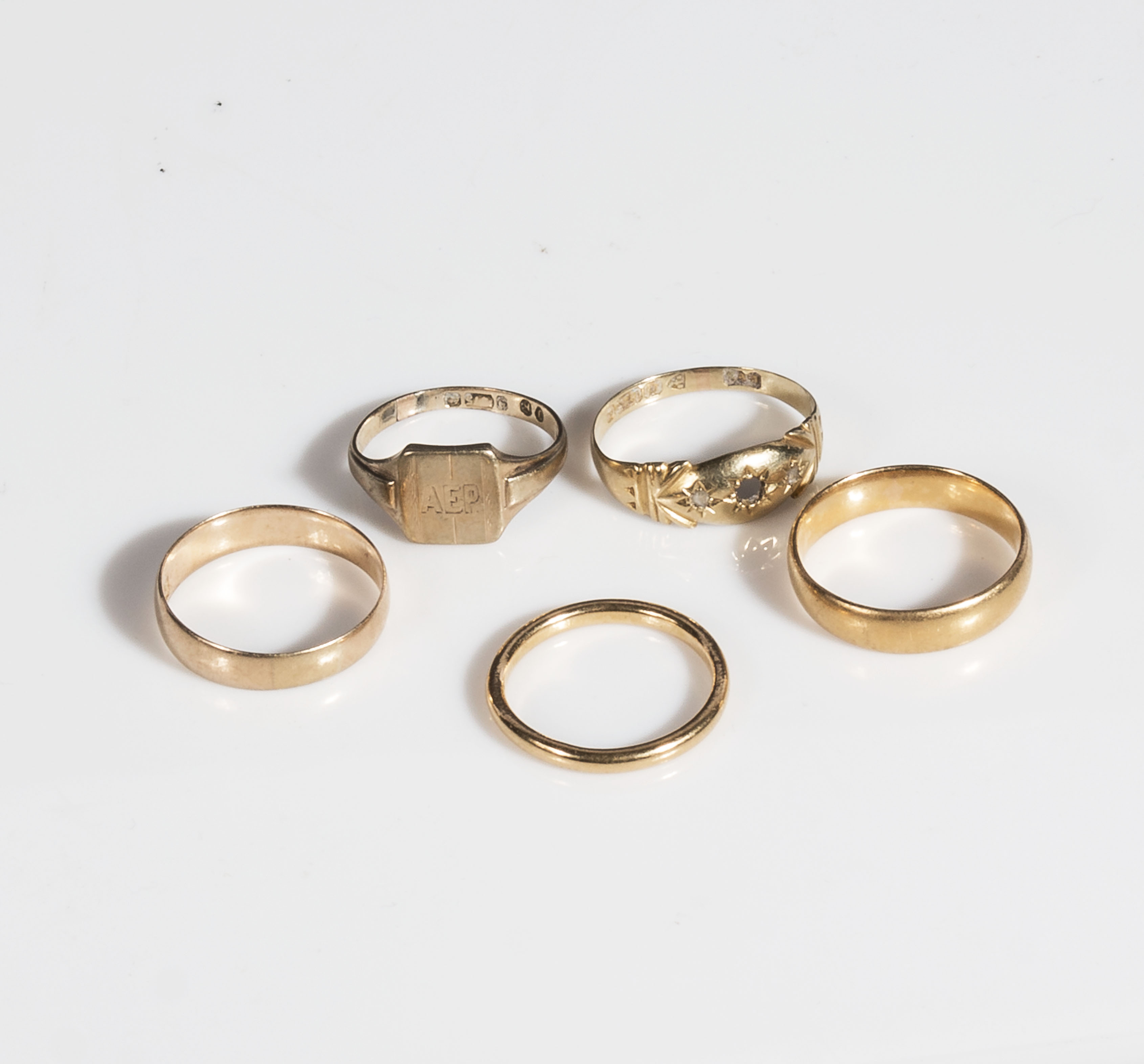 Three 9ct gold wedding bands and two others