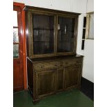 An Edwardian glazed oak bookcase on cupboards