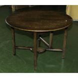 A small oak side table with drop leaf to one side.