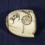 An ivory and bone netsuke rat in a sack