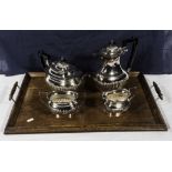 A four piece silver plated tea service and a wooden tray