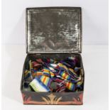 A tin containing a large amount of war medal ribbons