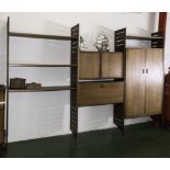 A retro teak wall unit with ladder sides, inset cupboards and bureau desk