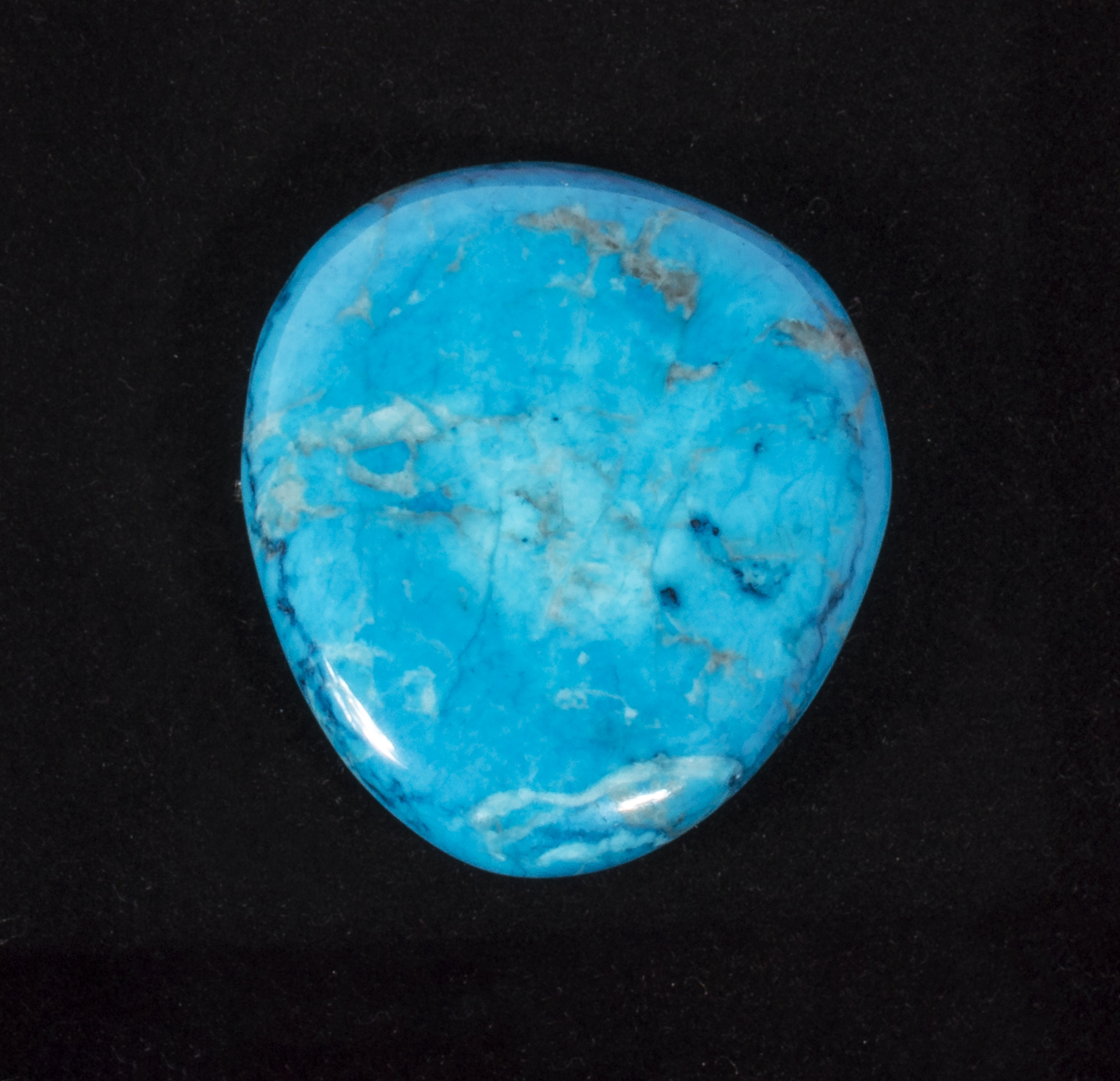 A turquoise howlite brooch