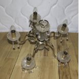 A glass and brass five branch ceiling light