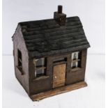 A small naive dolls house circa 1933