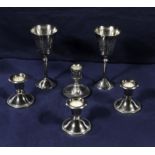 Four silver plated candlesticks and two goblets