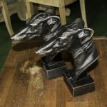 Two cast Greyhound heads