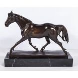 A large bronze horse on marble base