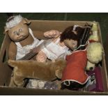 A box containing dolls and plush toys