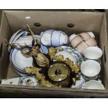 A box containing china tea ware and a barometer