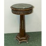 A marble topped pedestal