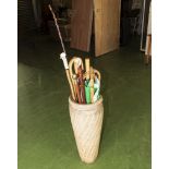 A pottery stick stand with contents.