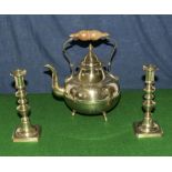 A brass kettle and a pair of brass candlesticks
