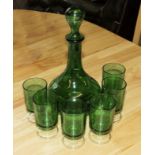 A green glass decanter and six glasses