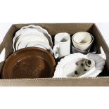 A box containing pottery dishes and other items