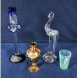 A glass candlestick, bird, vase and a glass