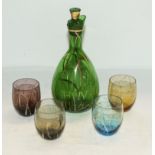 A glass wine carafe and four glasses