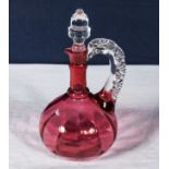 A cranberry glass wine decanter