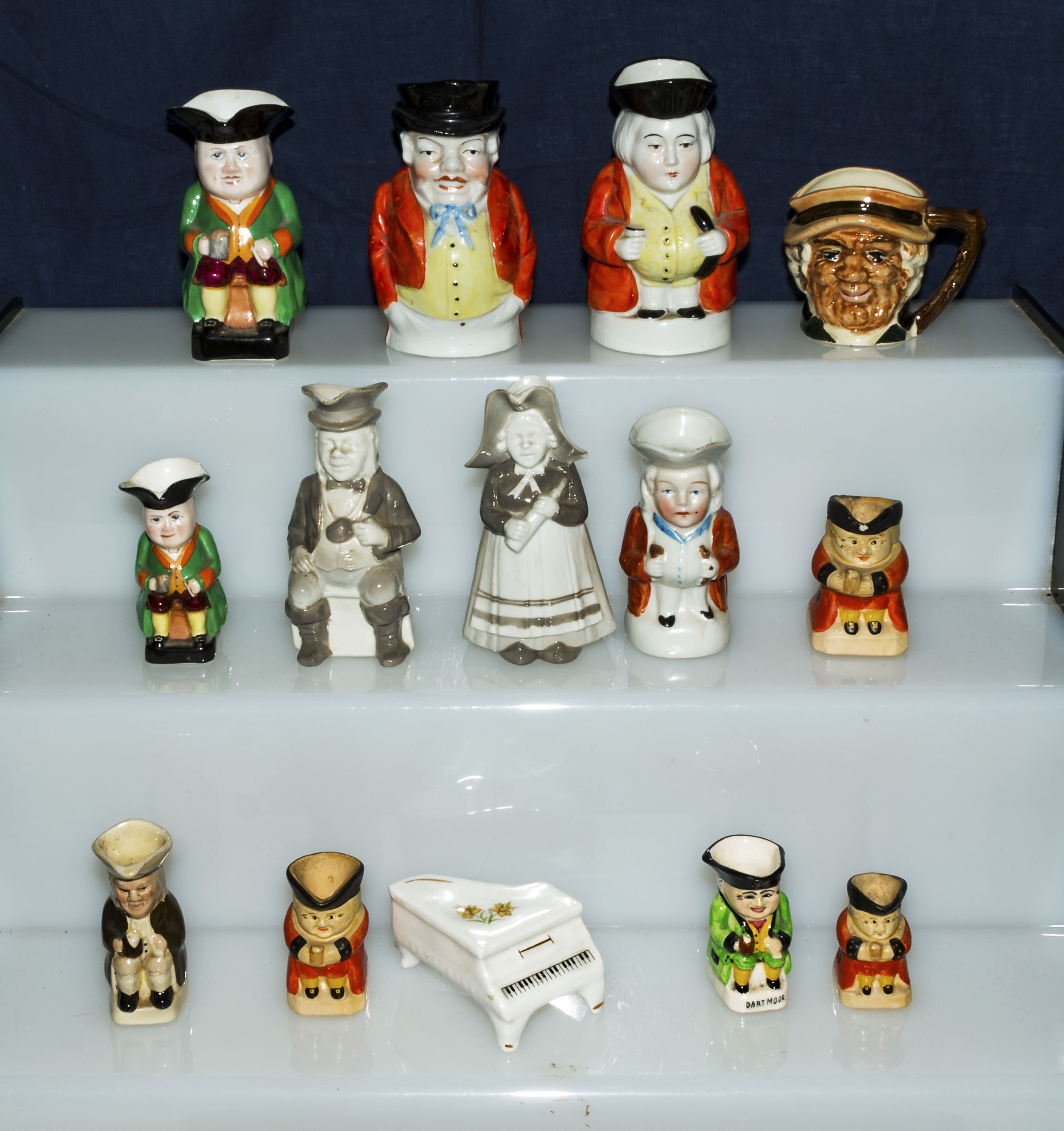 A collection of miniature character jugs