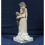 A Royal Copenhagen figure of a fawn sitting on a pillar with rabbit 1018/456