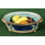 A Majolica basket with pottery fruit