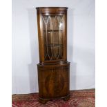 A reproduction mahogany corner cabinet