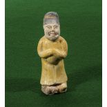 A small Ming dynasty style attendant figure with yellow glaze