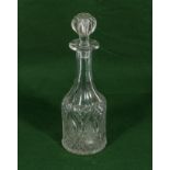 A glass wine decanter etched with bunches of grapes