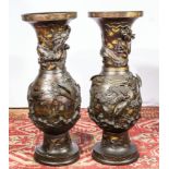 A pair of Japanese bronze vases with dragons etc some gold leaf decoration,