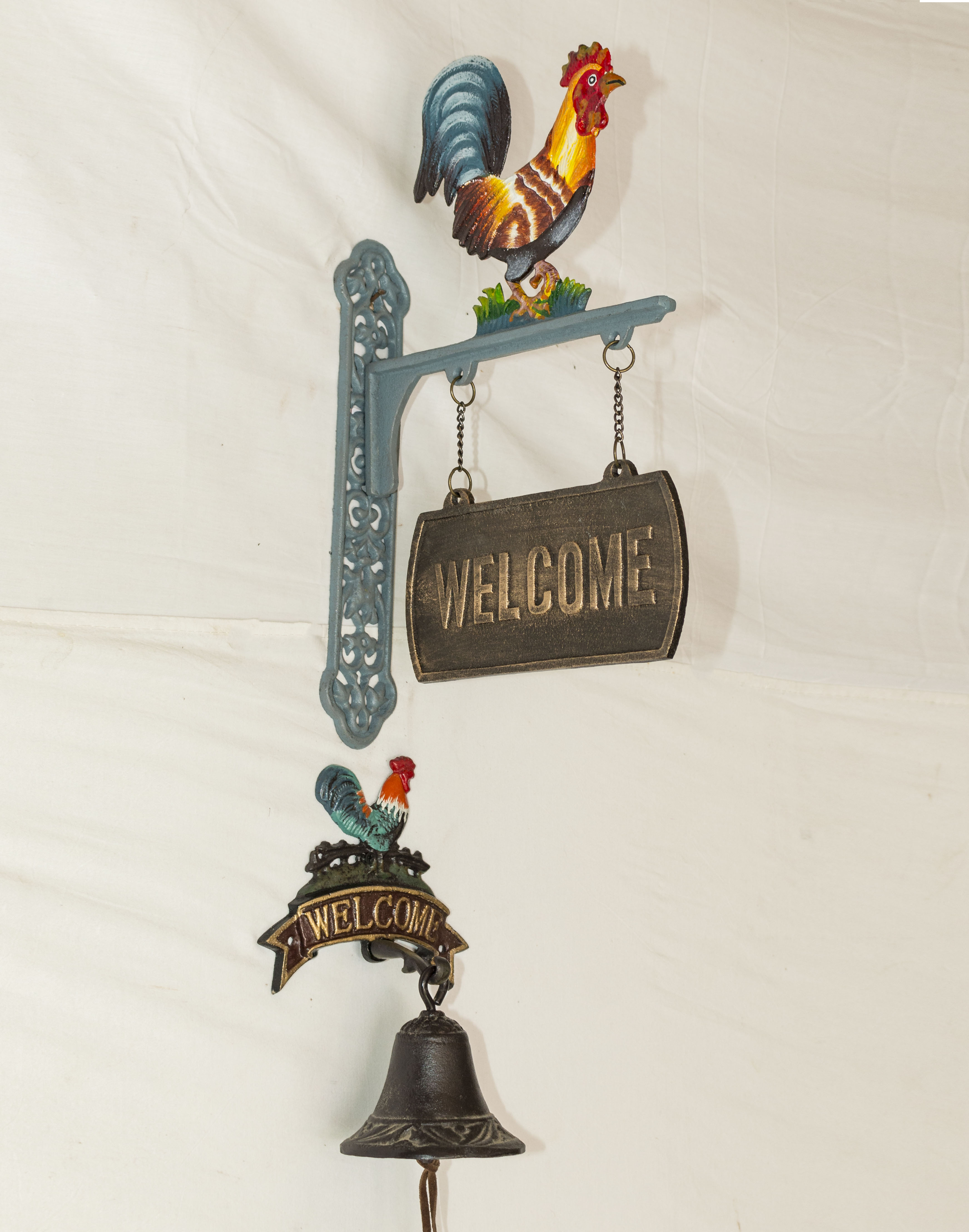 Large and small cast cockerel welcome signs