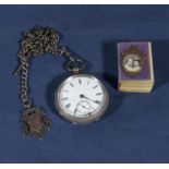 A silver pocket watch and a miniature bible