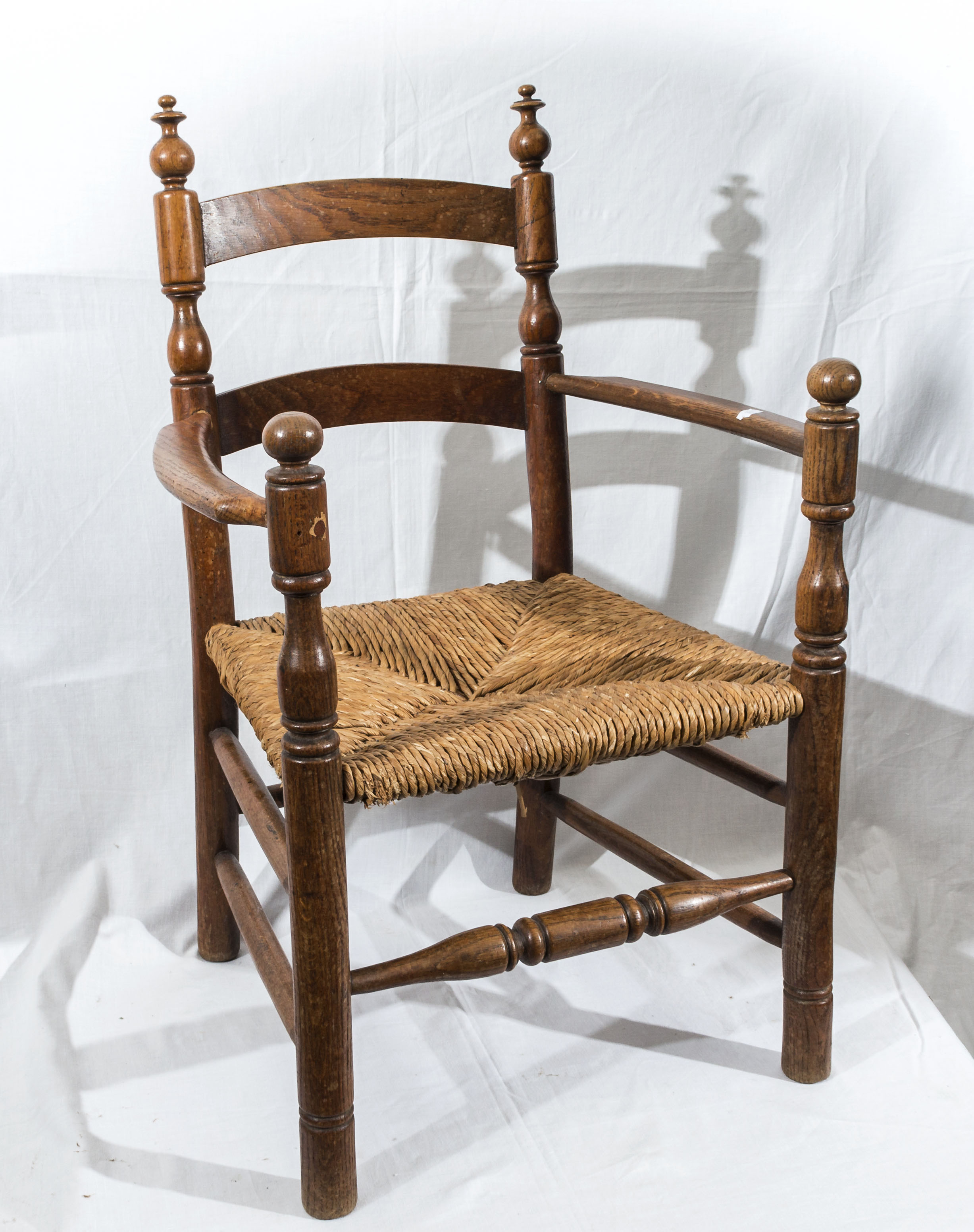 A small rush seated oak chair.