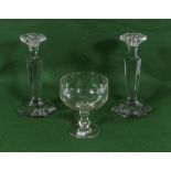 A pair of glass candlesticks and one other