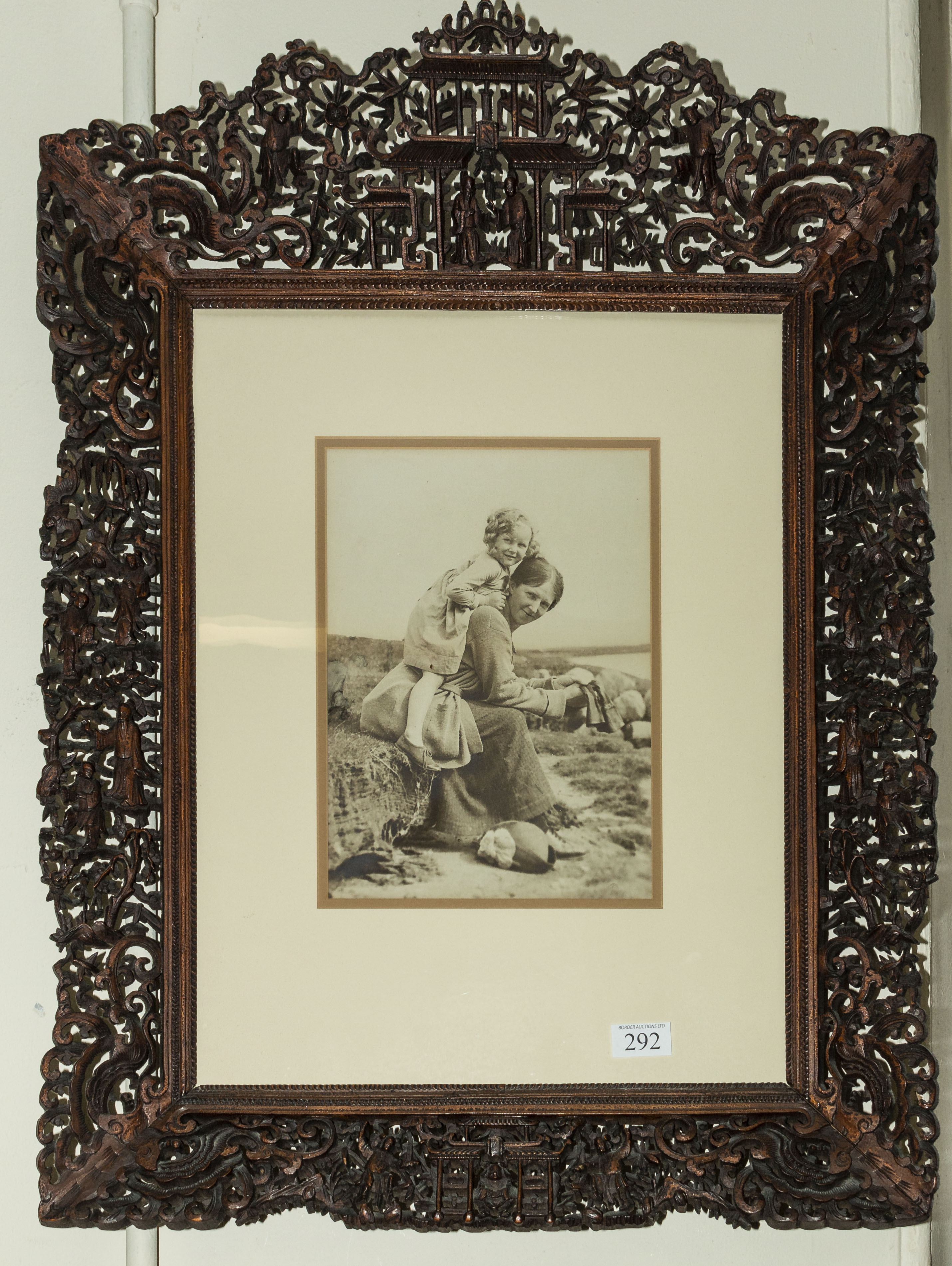 A good quality Chinese hardwood frame very well carved with figures and animals, 75cm x 55cm