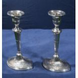 A pair of silver candlesticks marks for Sheffield 1893, filled bases