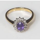 An 18ct yellow and white gold amethyst and diamond cluster, size O