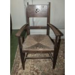 An oak rush seated arm chair