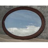 An Edwardian mahogany framed oval mirror