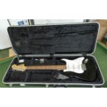 A Squier Stratocaster by Fender style electric guitar in a Voyager International Series case