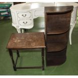 A corner open book shelf and a side table